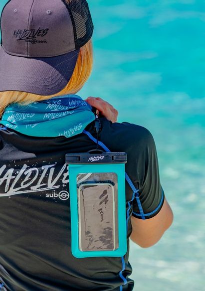 A Model carrying a Sub Oceanic Maldives Waterproof Phone Cover in Mint