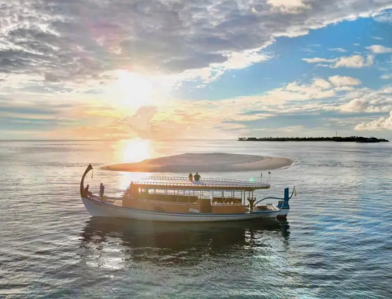 A Traditional Maldivian Boat "Dhoni" placed in front of the Sunset at Hilton Maldives Amingiri Resort & Spa